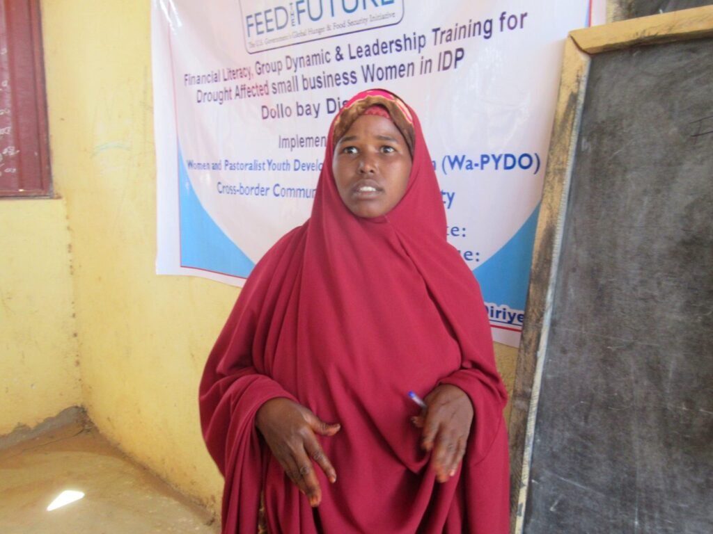 A woman speaks during a Feed the Future financial literacy, group dynamics and leadership training for drought-affected small business women in Dollo Bay district.