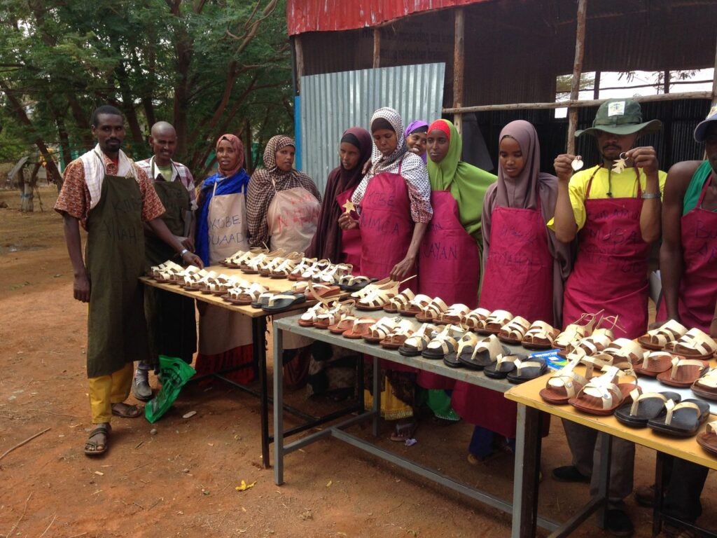 Trainees displaying leather sandals they produced, Dollo Ado refugee camps