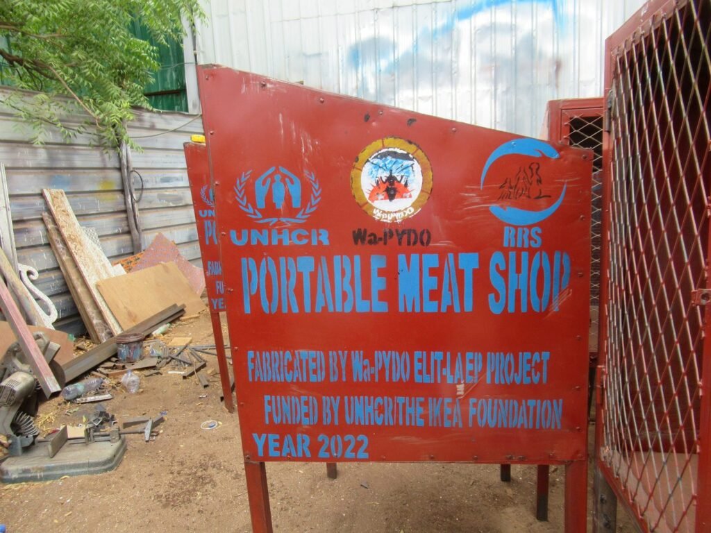 Signage for a portable meat shop set up through Wa-PYDO's livelihoods programme, funded by UNHCR and the IKEA Foundation.